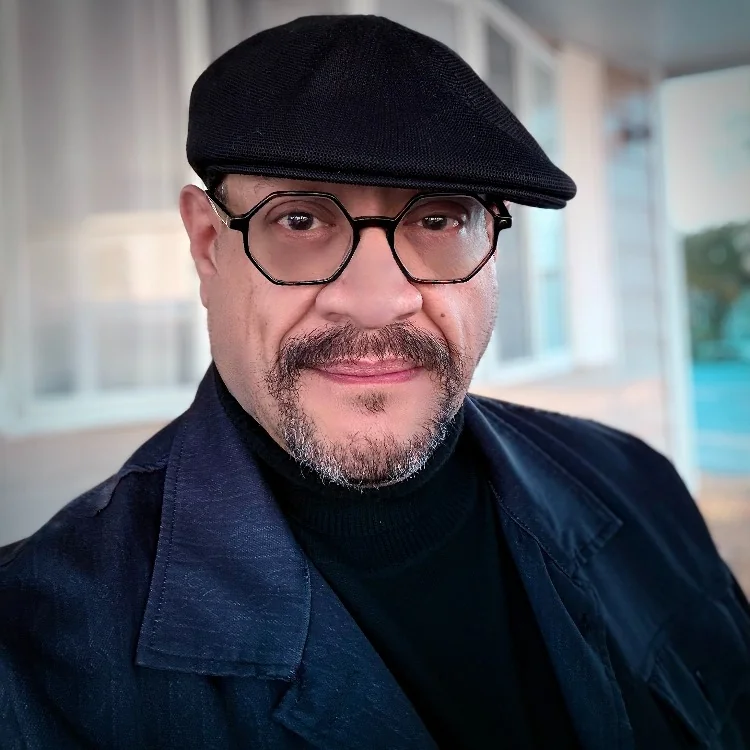 Portrait of LPE wearing a beret and glasses